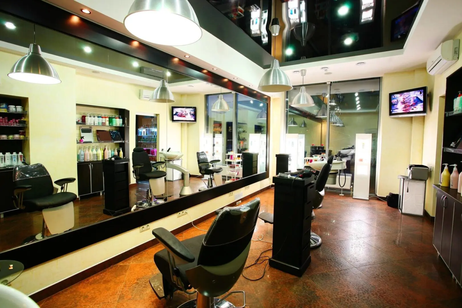 A hair salon with two chairs and mirrors